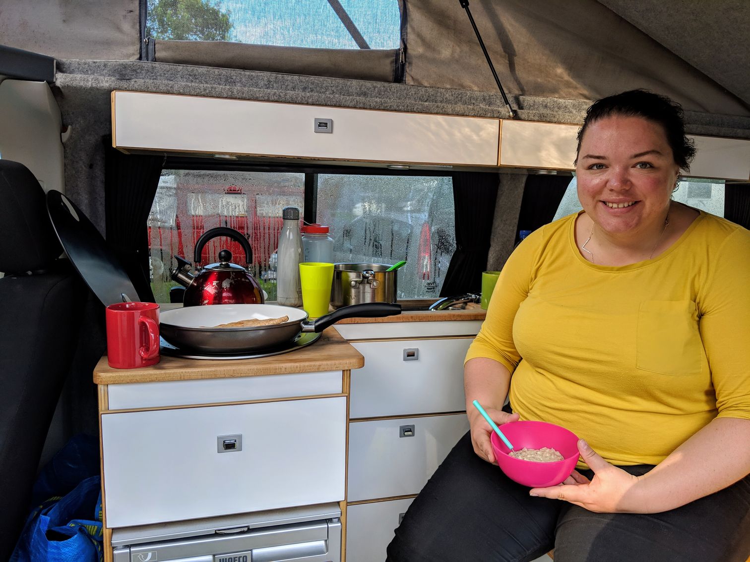 Alex eating breakfast in the campervan