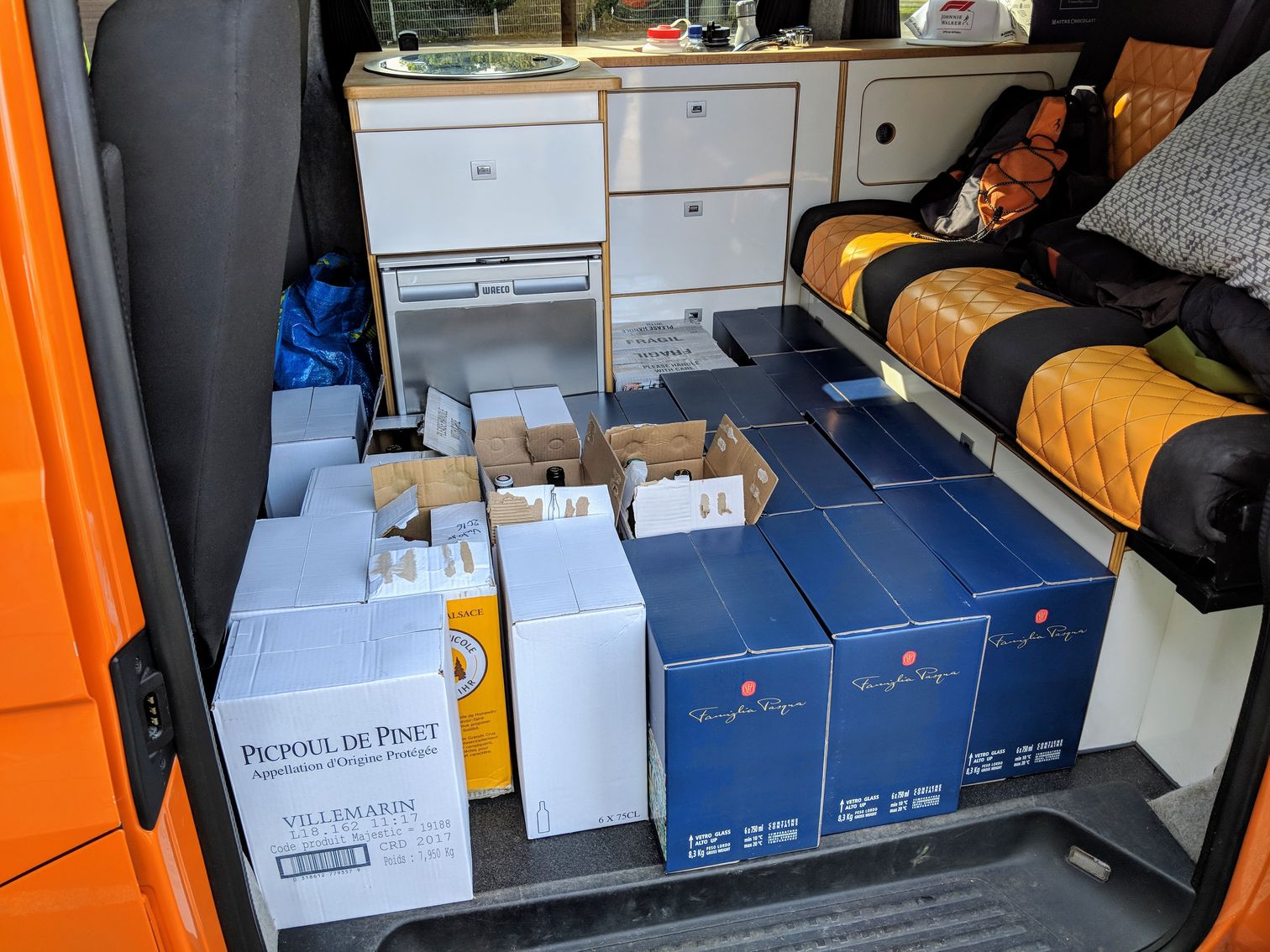 Many boxes of wine in the campervan
