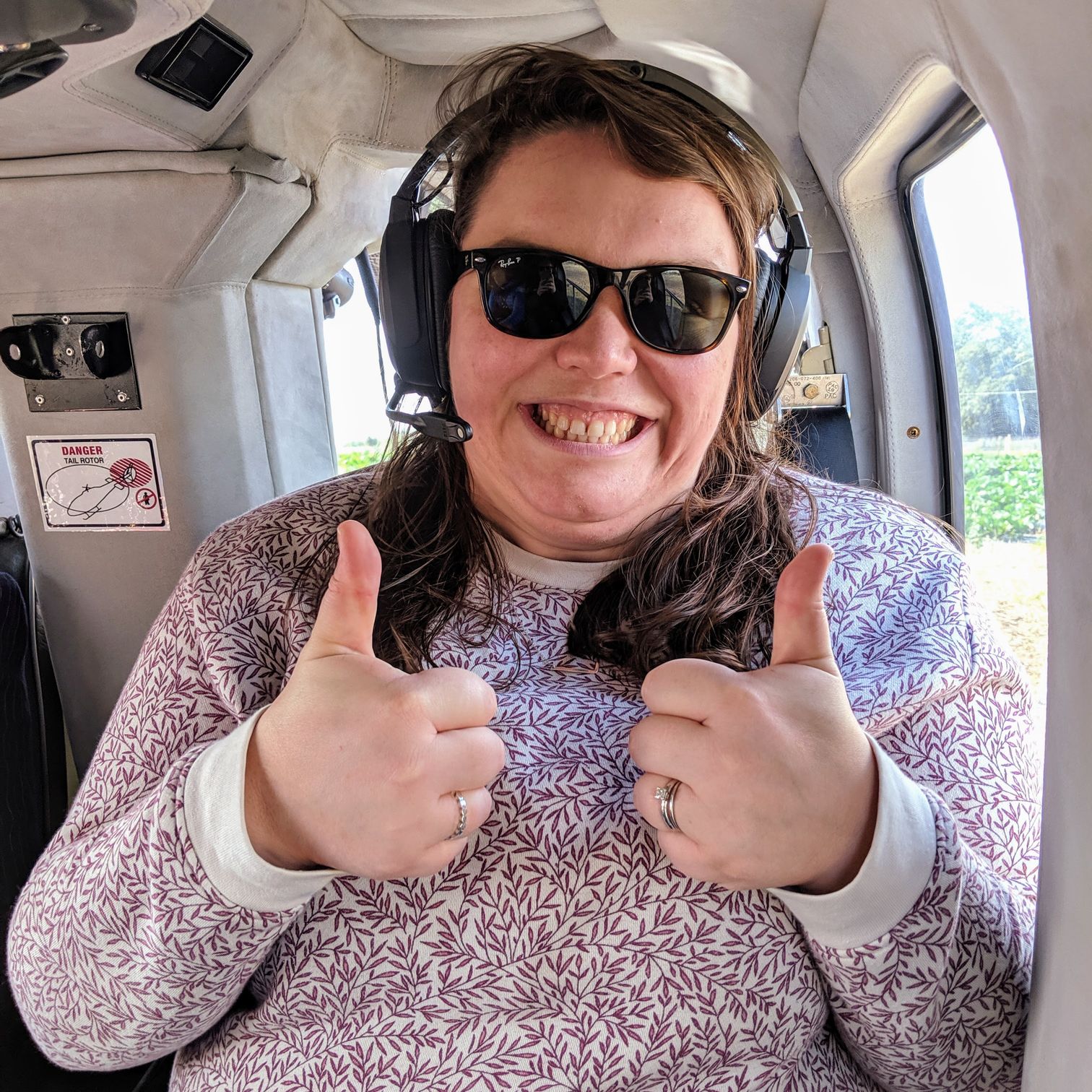 Alex with two thumbs up in the helicopter
