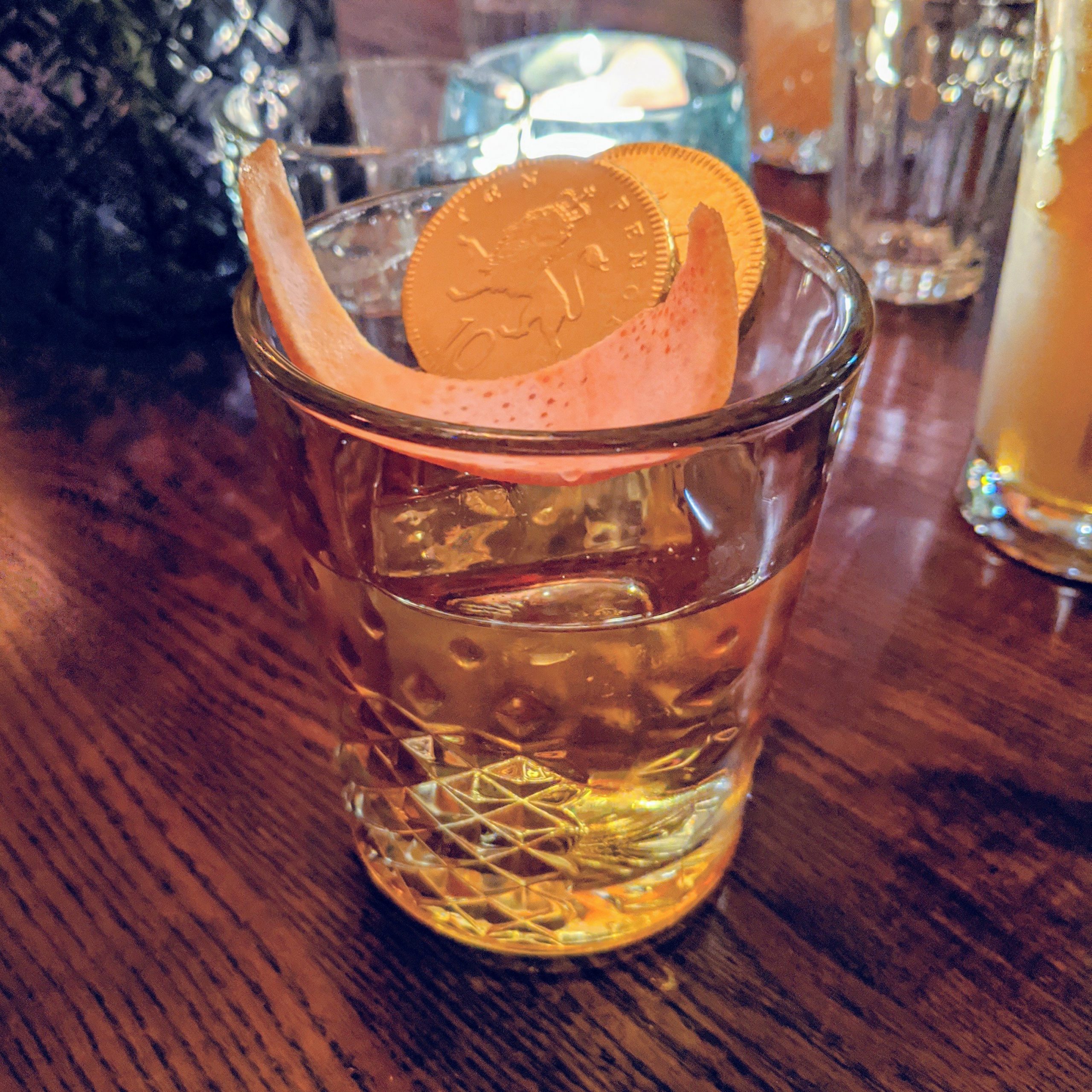 Old fashioned-style cocktail with chocolate coins in it