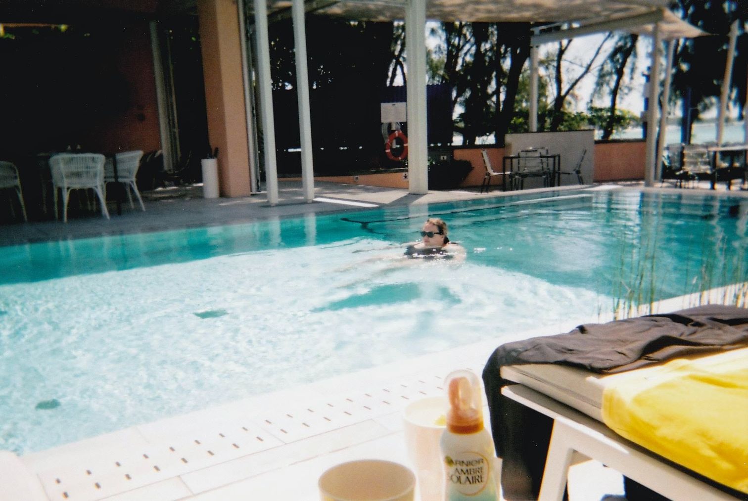 Alex floating in the pool (taken on the disposable camera)