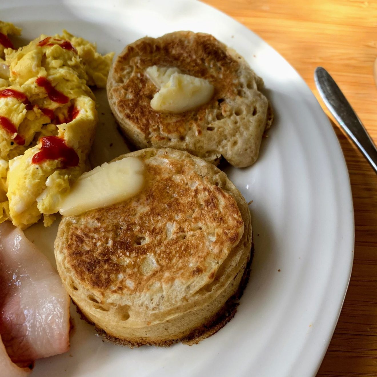 Crumpets on a plate with butter melting on them