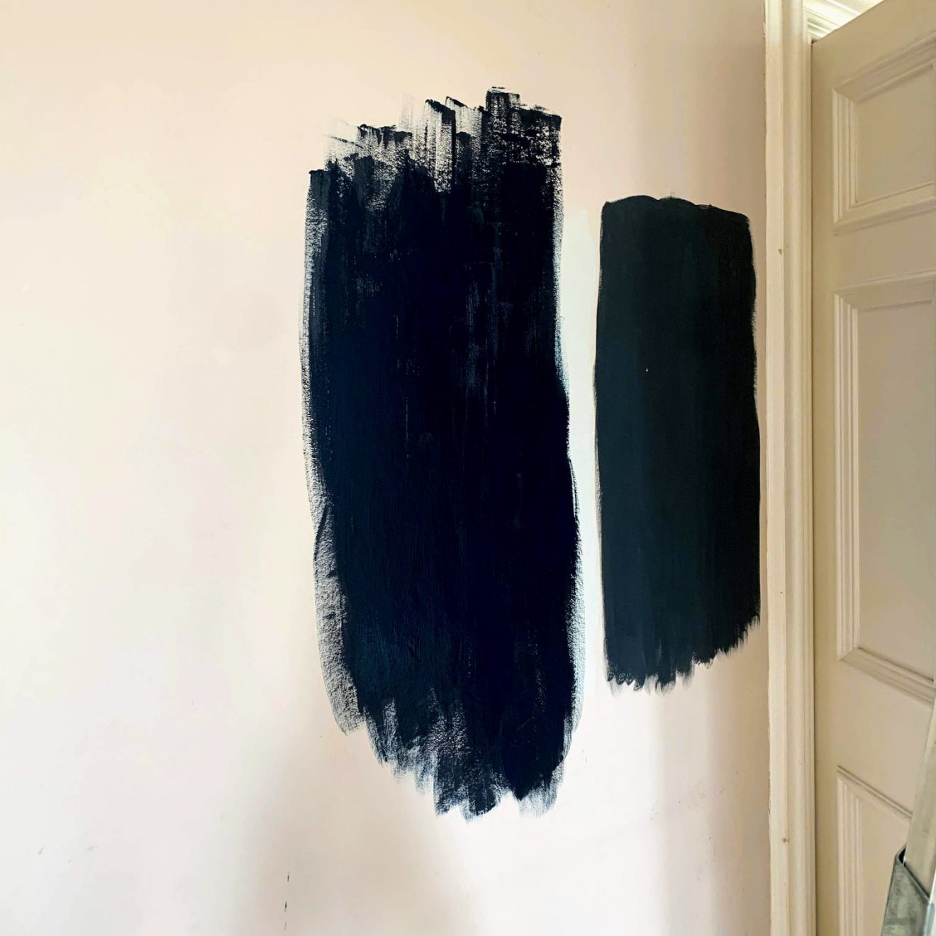 Two dark blue test patches on the wall