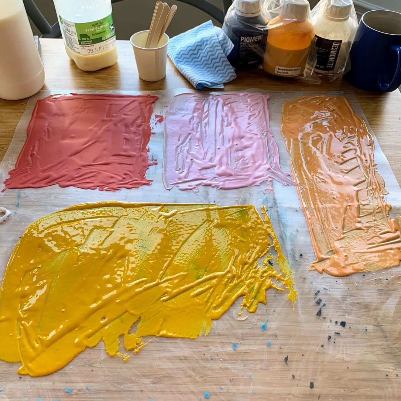 Jesmonite of various colours smeared onto a plastic sheet
