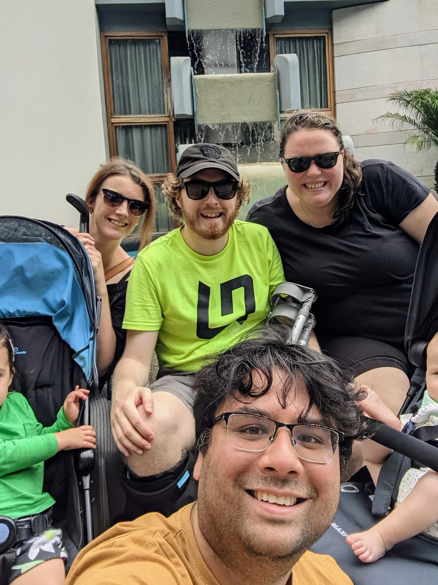 Louise, me, Jamie and Alex - with children (cropped out) - posing at a fountain in Madeira