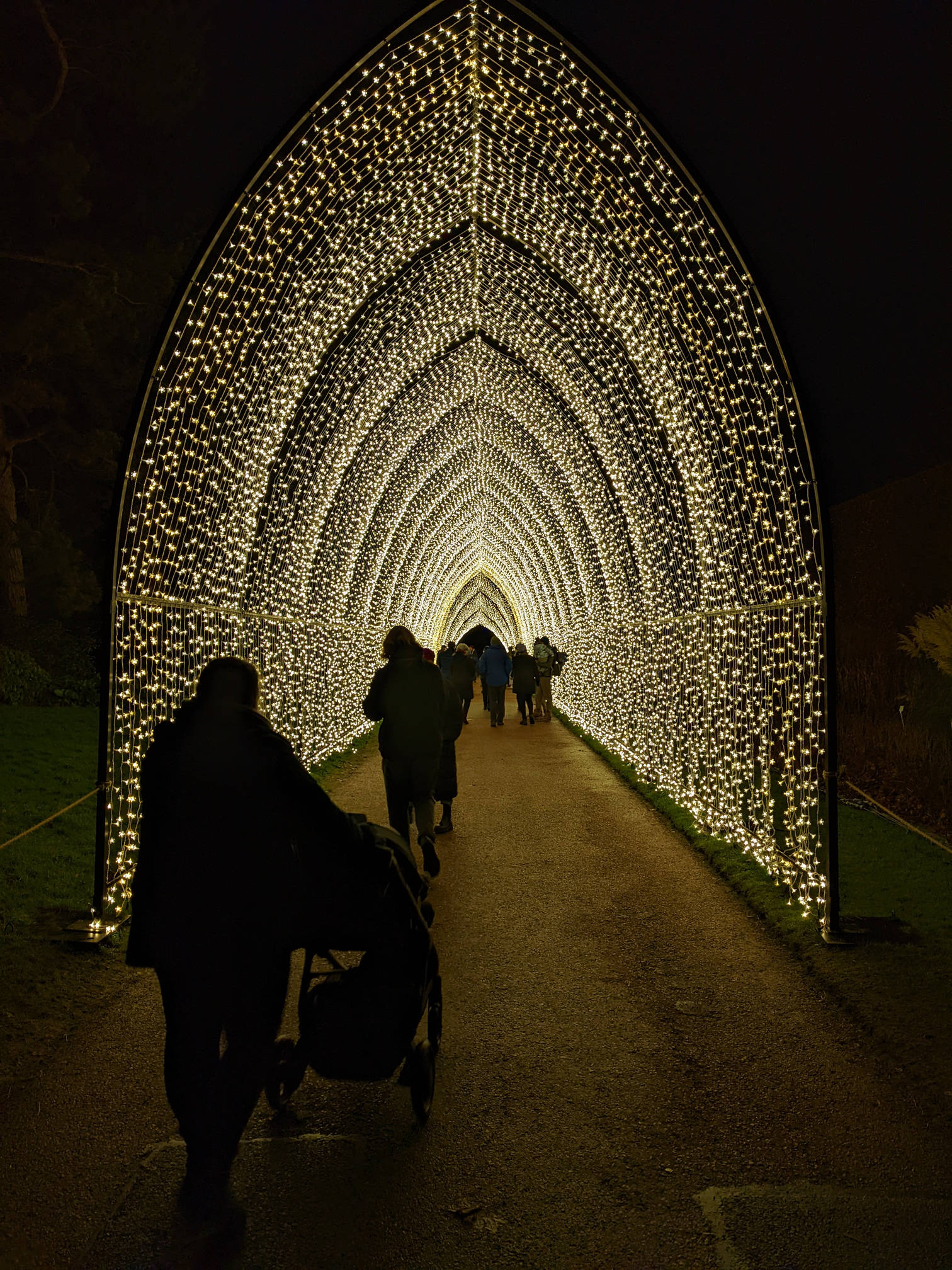 Alex and Izzy walking into an arched tunnel of light