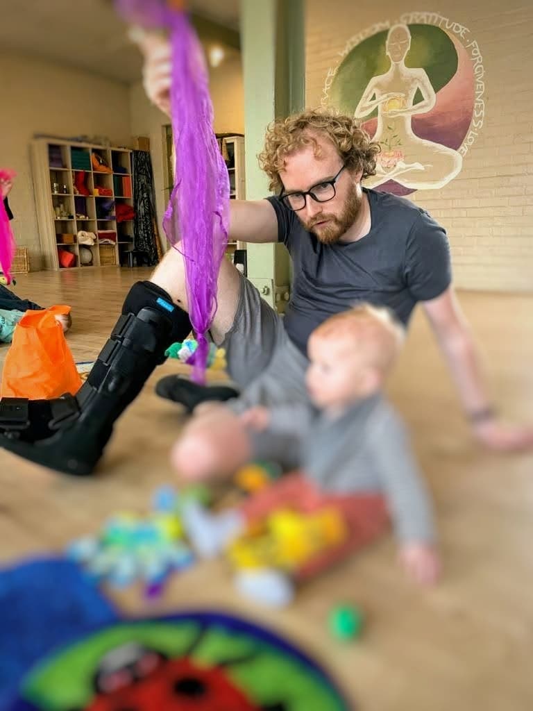 Me in a moon boot, playing with Izzy during a music class