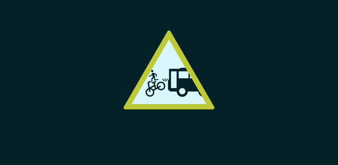 Mock road sign showing a person flying off a bike that has been hit by a bus