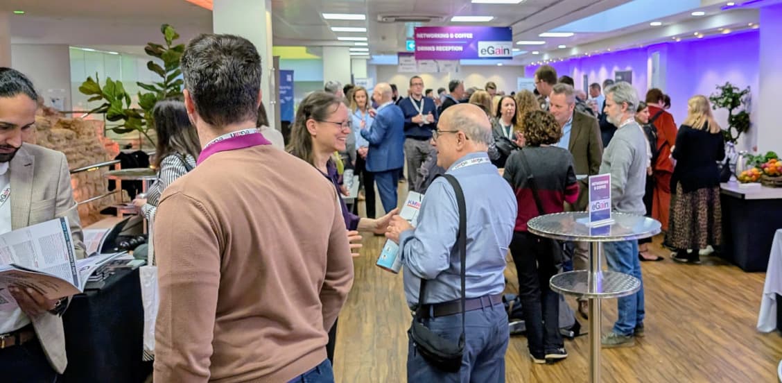 Conference attendees mingling in a room